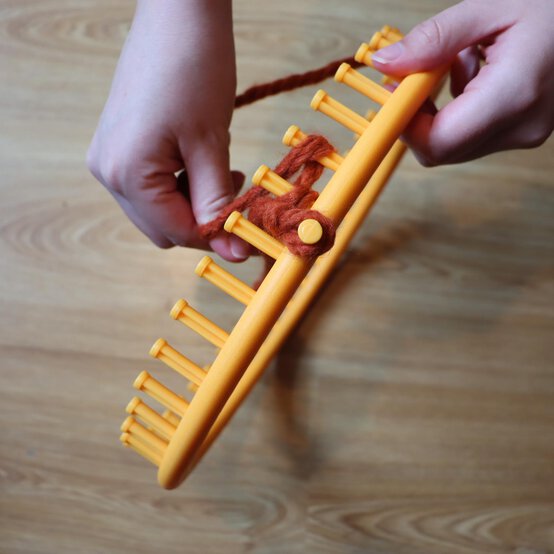 how_to_loom_knit_a_twisted_ear_warmer_step_2b.jpg?sw=554&q=85