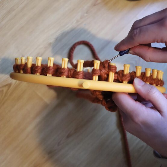 how_to_loom_knit_a_twisted_ear_warmer_step_8b.jpg?sw=554&q=85