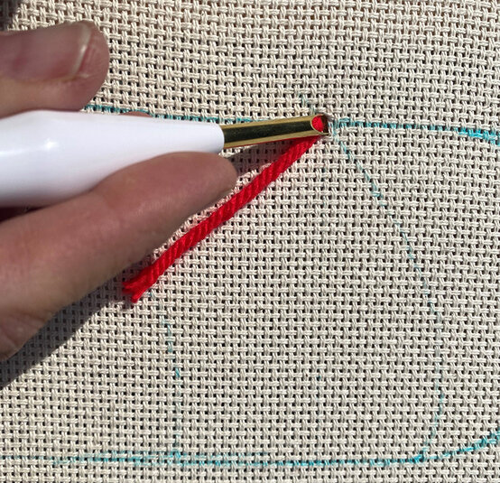 how-to-punch-needle-a-candy-cane-cushion_step_4_first_stitch.jpg?sw=554&q=85