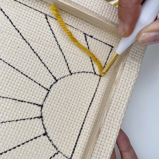 how-to-make-a-punch-needle_sunburst_first_stitch-step_6.jpg?sw=554&q=85