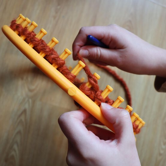 how_to_loom_knit_a_twisted_ear_warmer_step_7a.jpg?sw=554&q=85