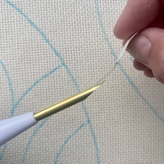 how-to-make-punch-needle-winter-trees_step_3a_threading_needle.jpg?sw=554&q=85