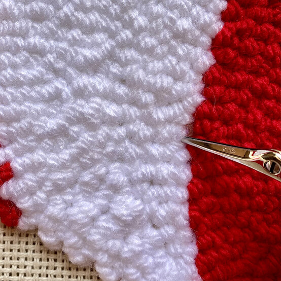 how-to-punch-needle-a-candy-cane-cushion_step_7_tidying_stitches.jpg?sw=554&q=85