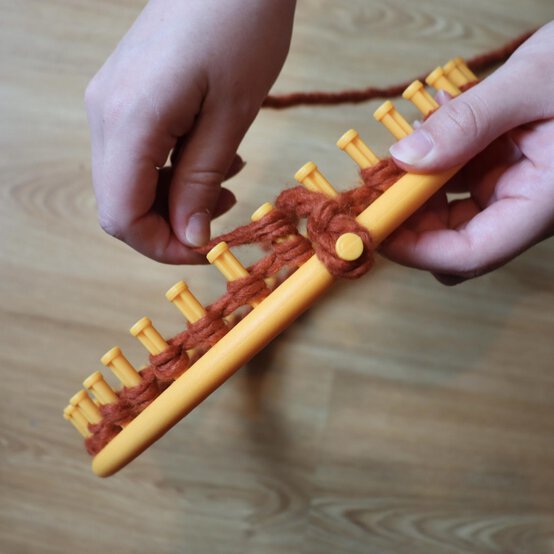 how_to_loom_knit_a_twisted_ear_warmer_step_3a.jpg?sw=554&q=85